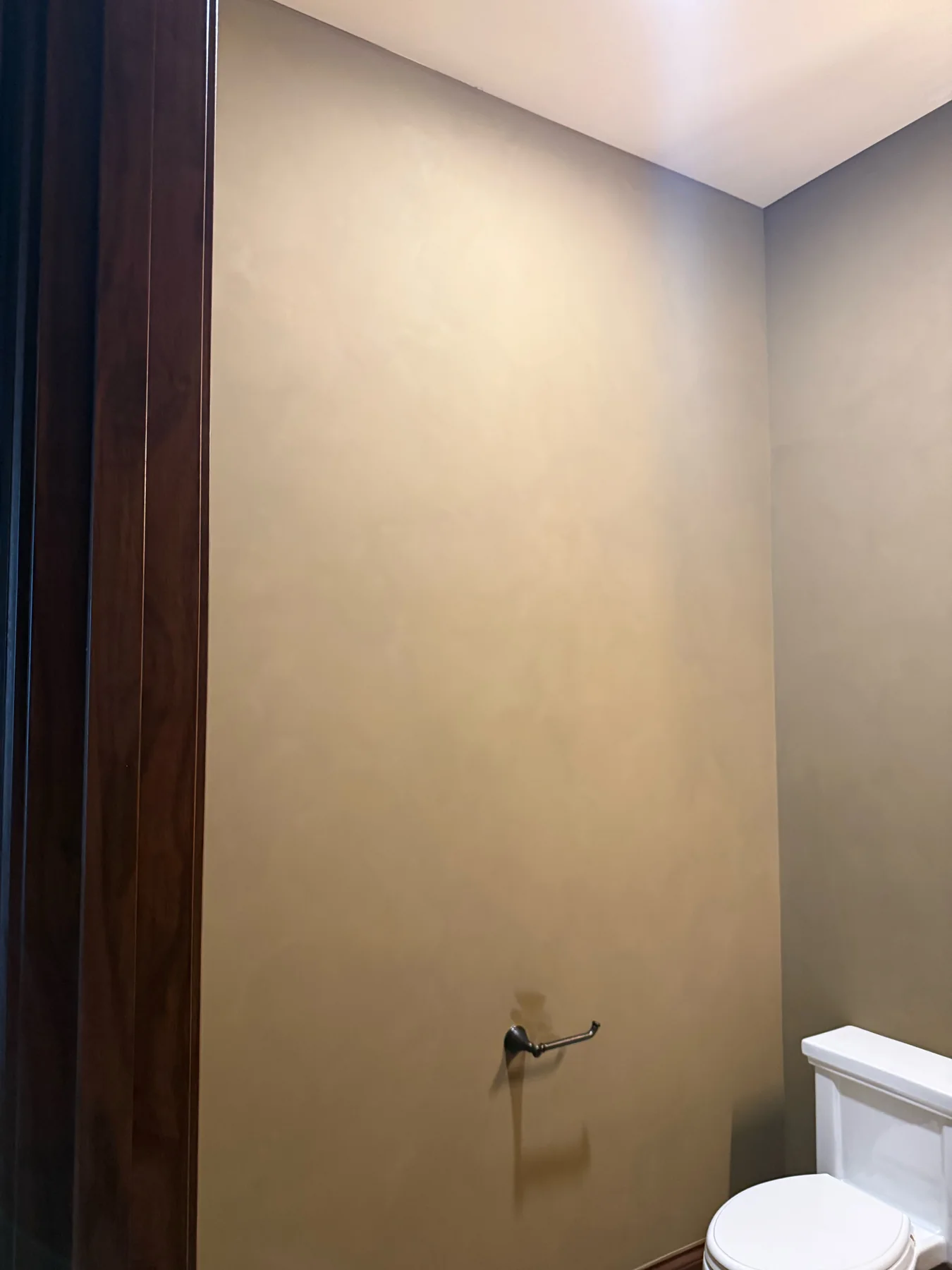 Warm limewash walls in a powder room before the vanity, sink, and wall lighting were installed
