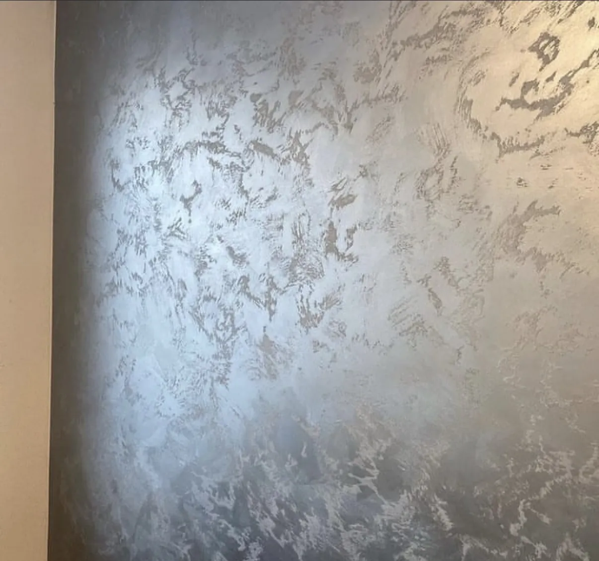 Close study of silvery gray Venetian plaster with feathery reflective movement