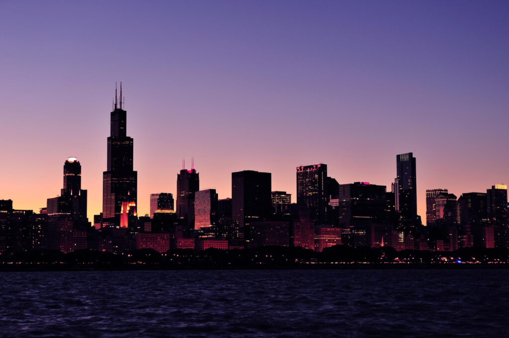 Chicago skyline at dusk with illuminated skyscrapers