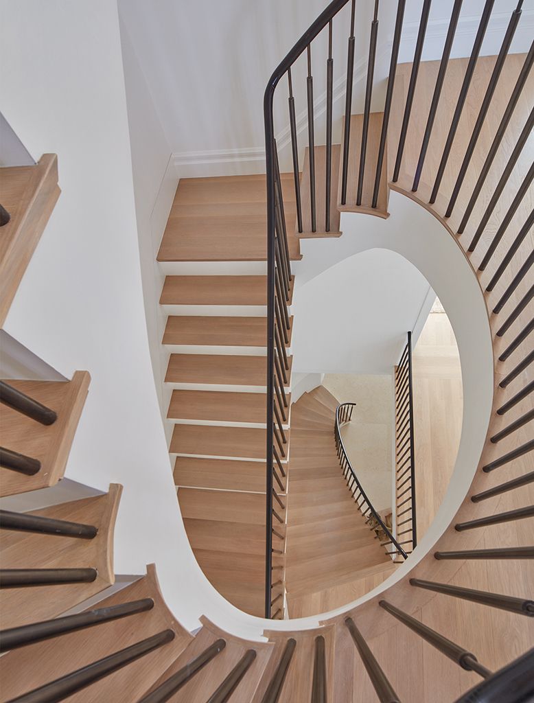 Wooden staircase with metal railing in a minimalist interior